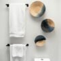 Small bathroom with organized shelves, towels and toiletries