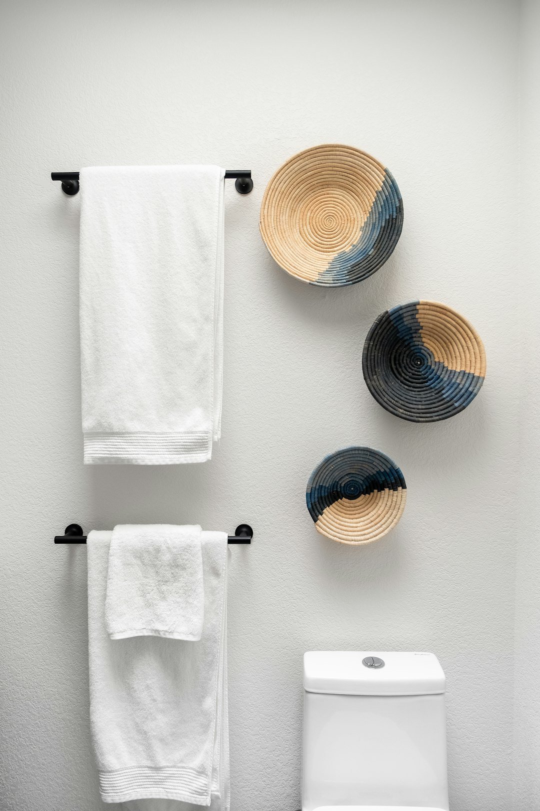 Small bathroom with organized shelves, towels and toiletries