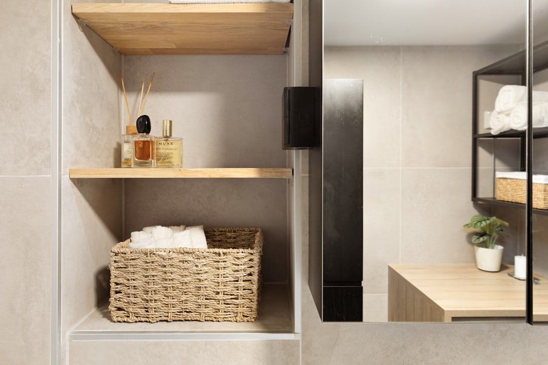 A small bathroom featuring a sink, mirror and organized shelves for practical storage