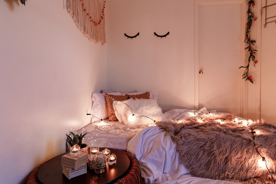 A cozy boho small room decorated with candles and string lights for warm layered lighting