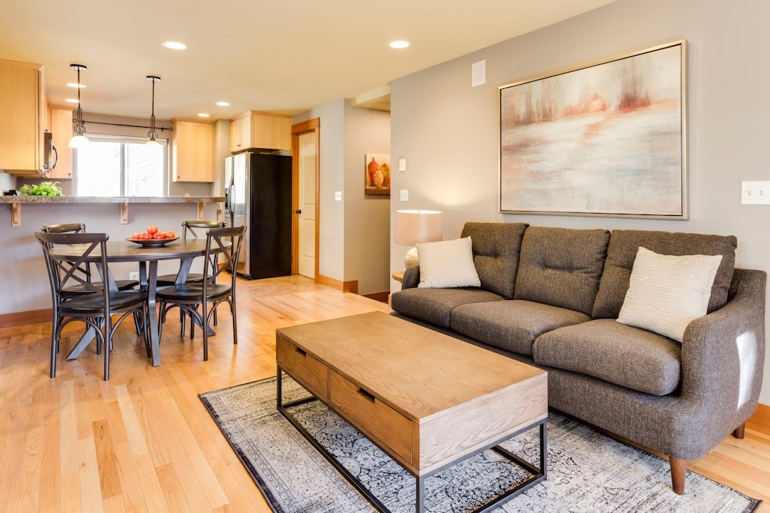A gray sofa and wooden coffee table arranged in a small living room for a cozy layout