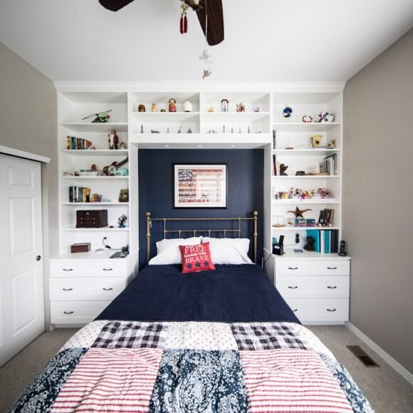 A small bedroom with smart storage organization solutions including shelving and under-bed storage