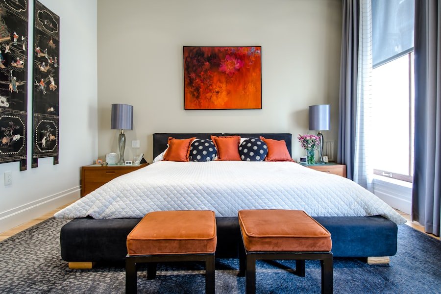 A small bedroom with a bed on legs and multi-purpose storage ottoman creating a sense of open space