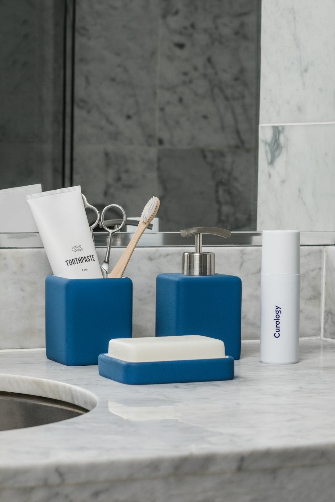 Matching bathroom accessories including soap dispenser and containers