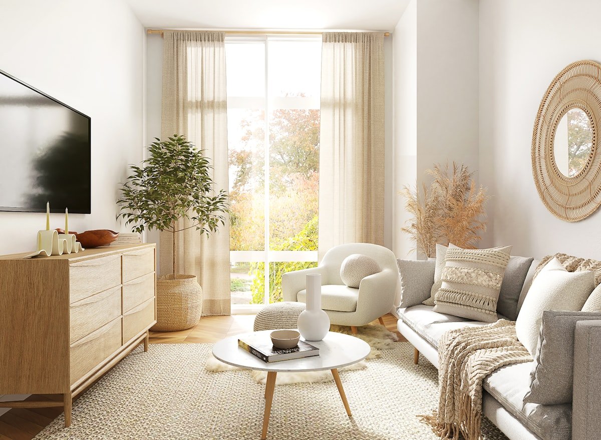 White and grey armchair beside a window in a small apartment living room