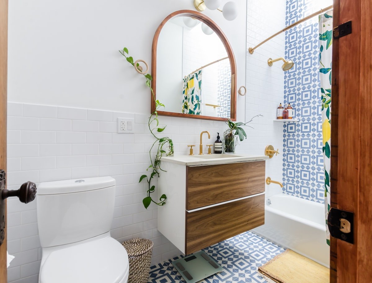 Bathroom with plants, baskets and decanted products on open shelving