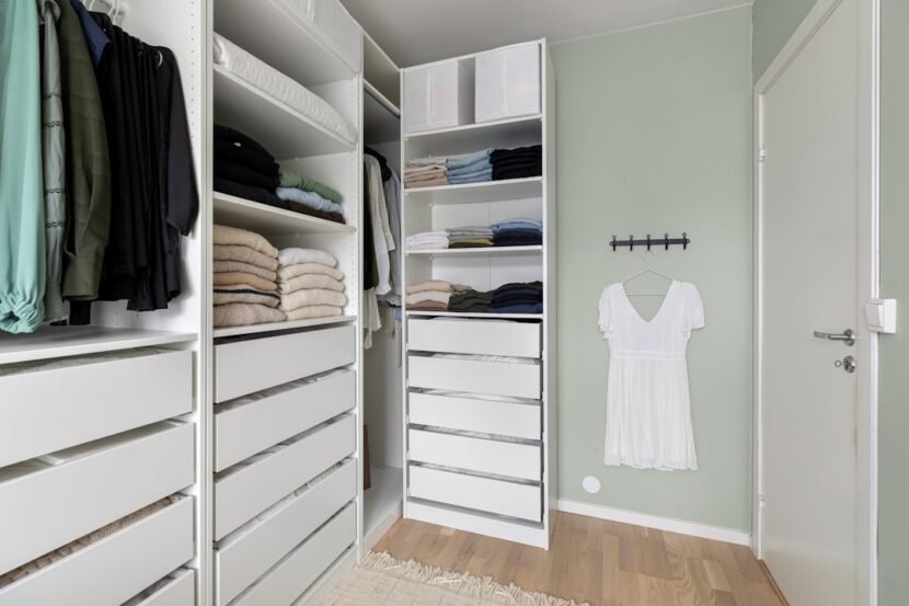 Closet Organization Ideas for Small Closets That Actually Work A small walk-in closet neatly organized with white drawers, hanging clothes, and labeled storage bins