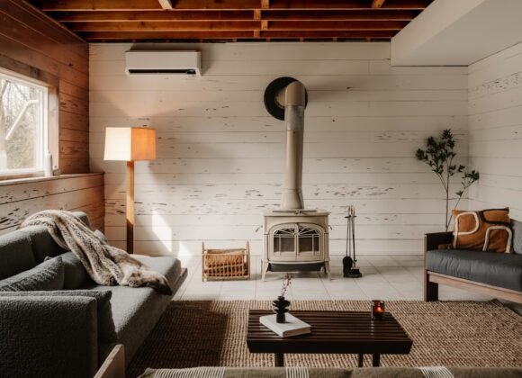 A cozy cottagecore-style living room filled with warm wood tones, soft textiles, and vintage charm