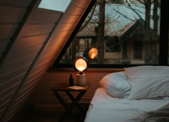 Cozy Bedroom Ideas for Deep Sleep and Slow Mornings A cozy bed with soft linens positioned under a sunlit window, creating a peaceful morning atmosphere