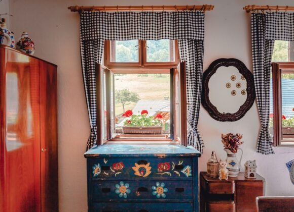 Blue painted wooden dresser with a mirror in a cottage bedroom