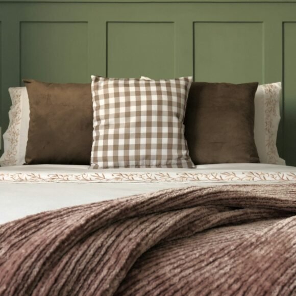Fall Bedroom Decor Ideas That Cost Almost Nothing Bed layered with a folded knit blanket and mixed cushions