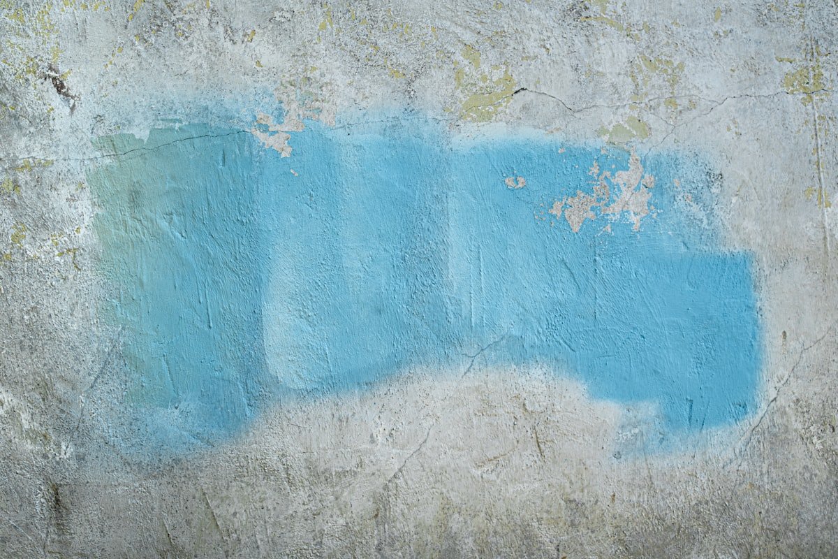 Close up of a blue painted wall surface showing colour and texture