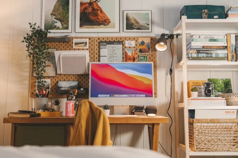 A tidy, compact home office workstation with a laptop, desk accessories, and natural light for a focused work-from-home setup