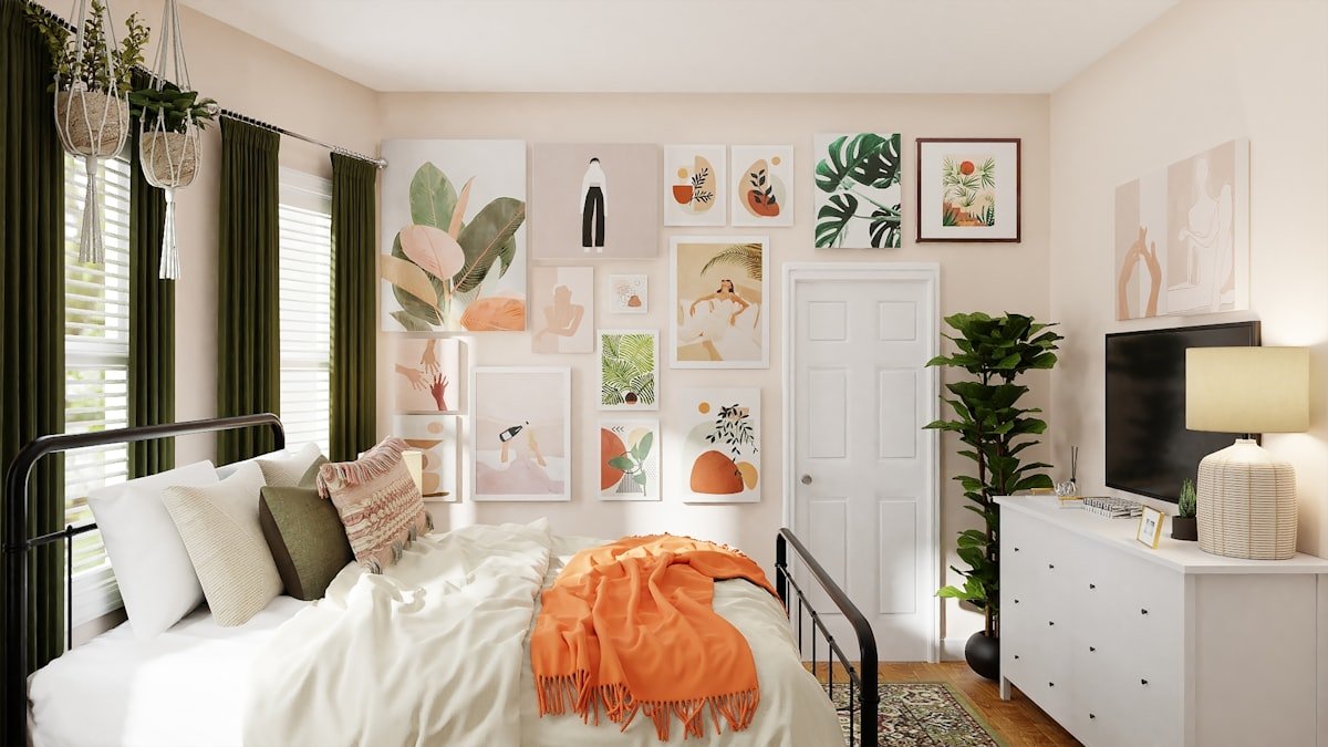 White bed layered with a folded rust coloured blanket