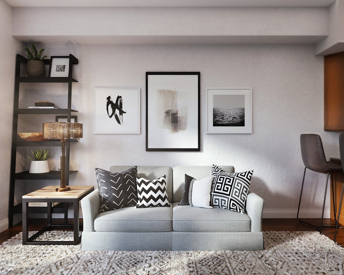 Black and white throw cushions layered on a white couch
