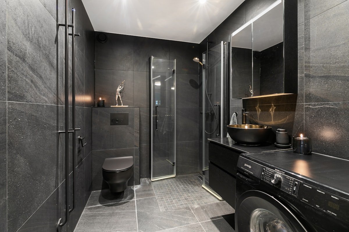 Modern small bathroom with vertical shelving and neutral towels