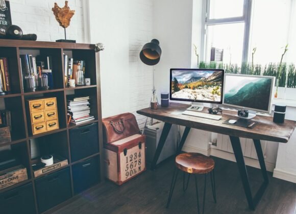 Small productivity room setup with desk facing the wall and task lighting