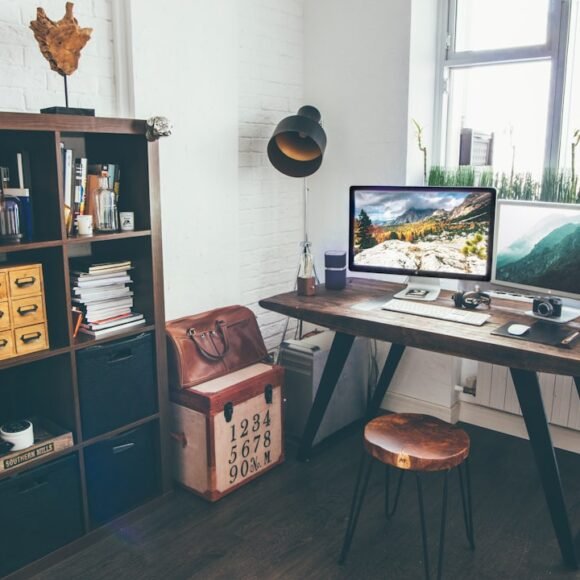 Small productivity room setup with desk facing the wall and task lighting