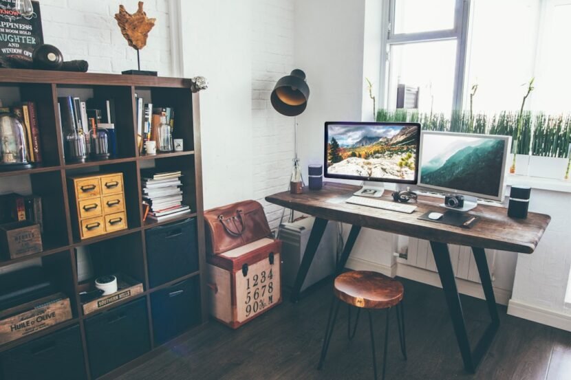 Small productivity room setup with desk facing the wall and task lighting
