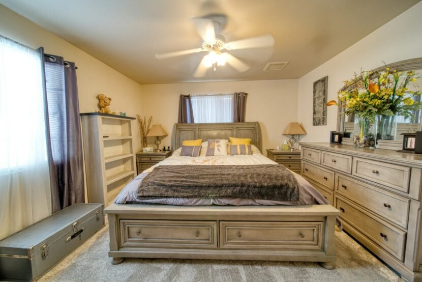 Calm bedroom with dresser storage and mirror keeping surfaces clear of clutter