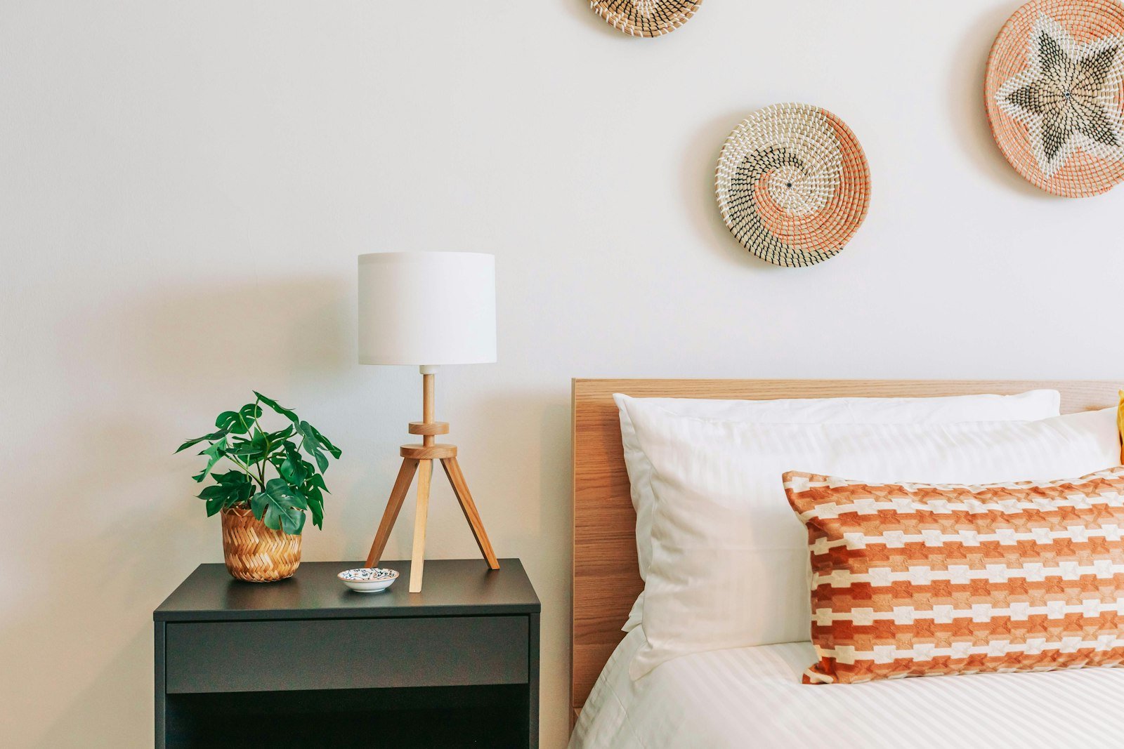 Bedside table kept clear with a closed drawer hiding everyday clutter