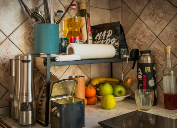 Kitchen Organization Ideas That Keep Counters Clear for Good Clear kitchen counter with fruit, spices and utensils