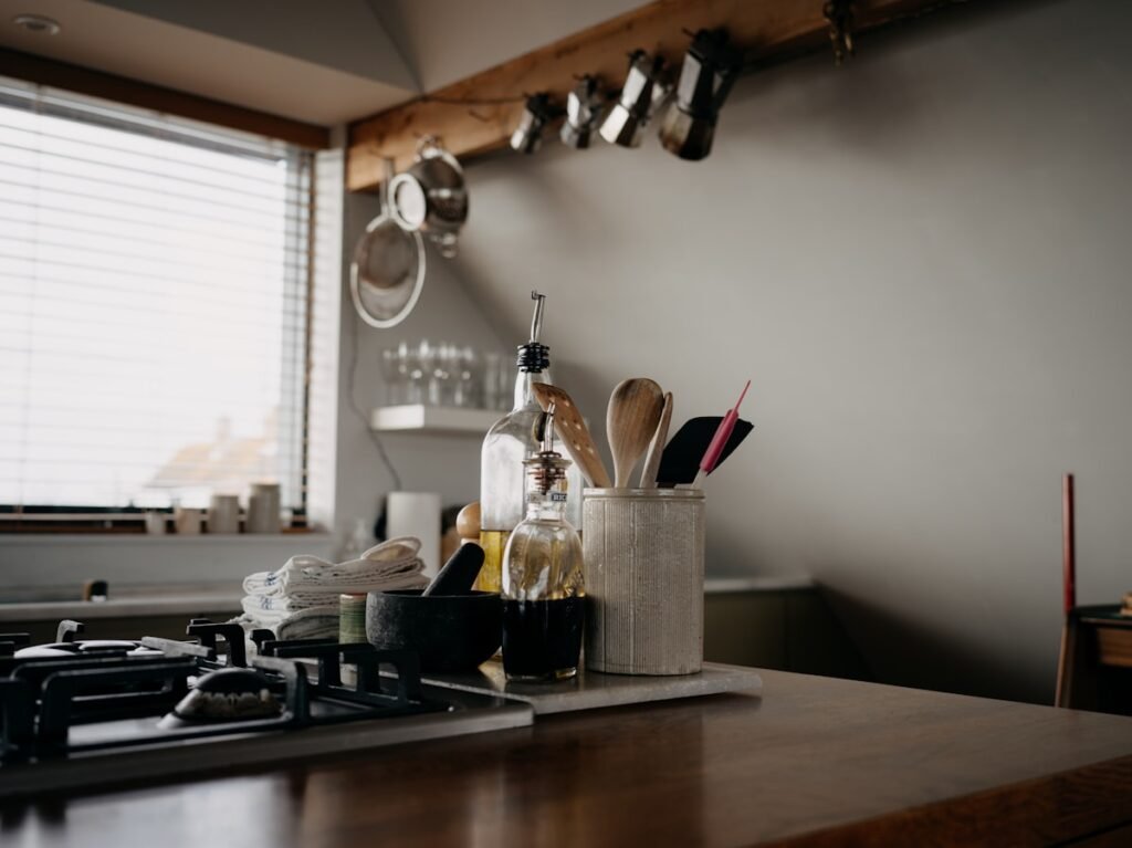 Kitchen counter with cooking utensils and decanted bottles