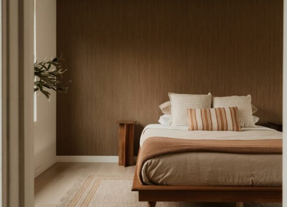 Warm minimalist bedroom with layered linen bedding and soft natural light