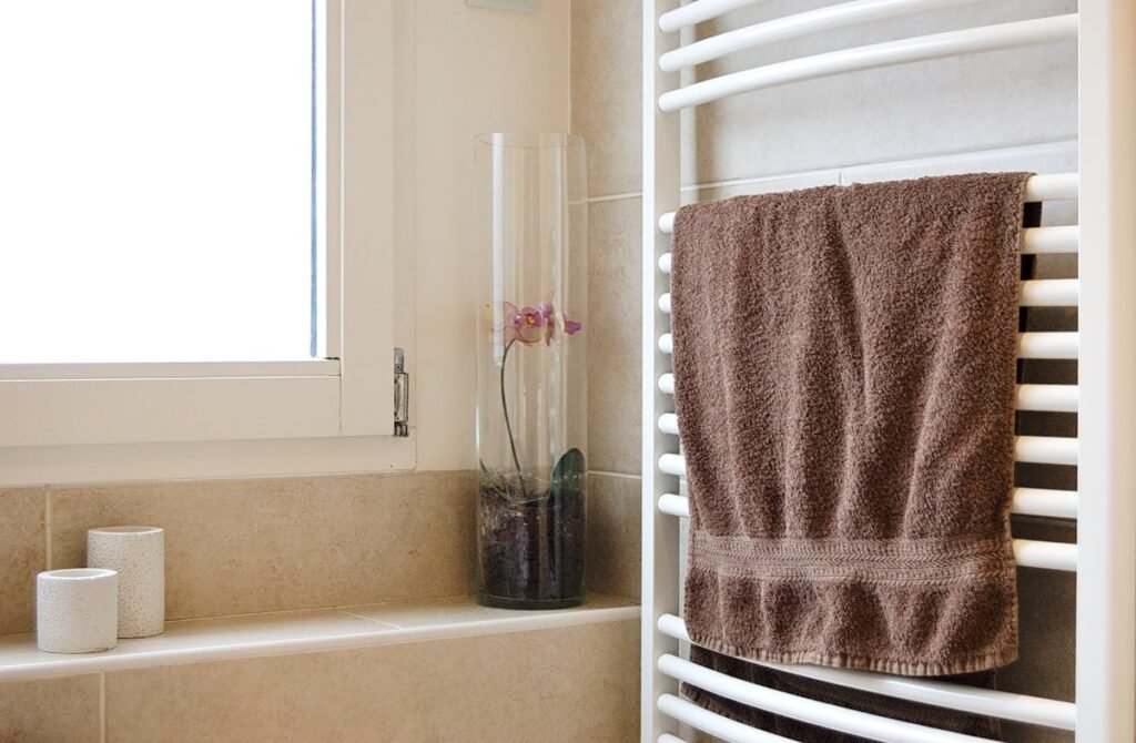 Towel on a rail in a bathroom with natural stone tiles