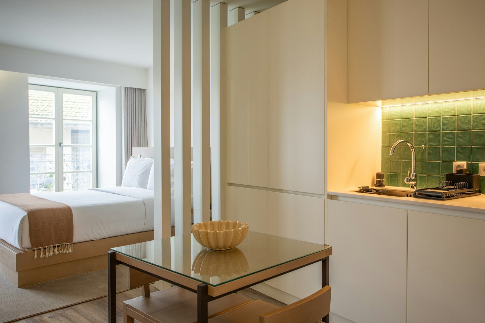 Studio apartment layout with the bed zoned away from the living area