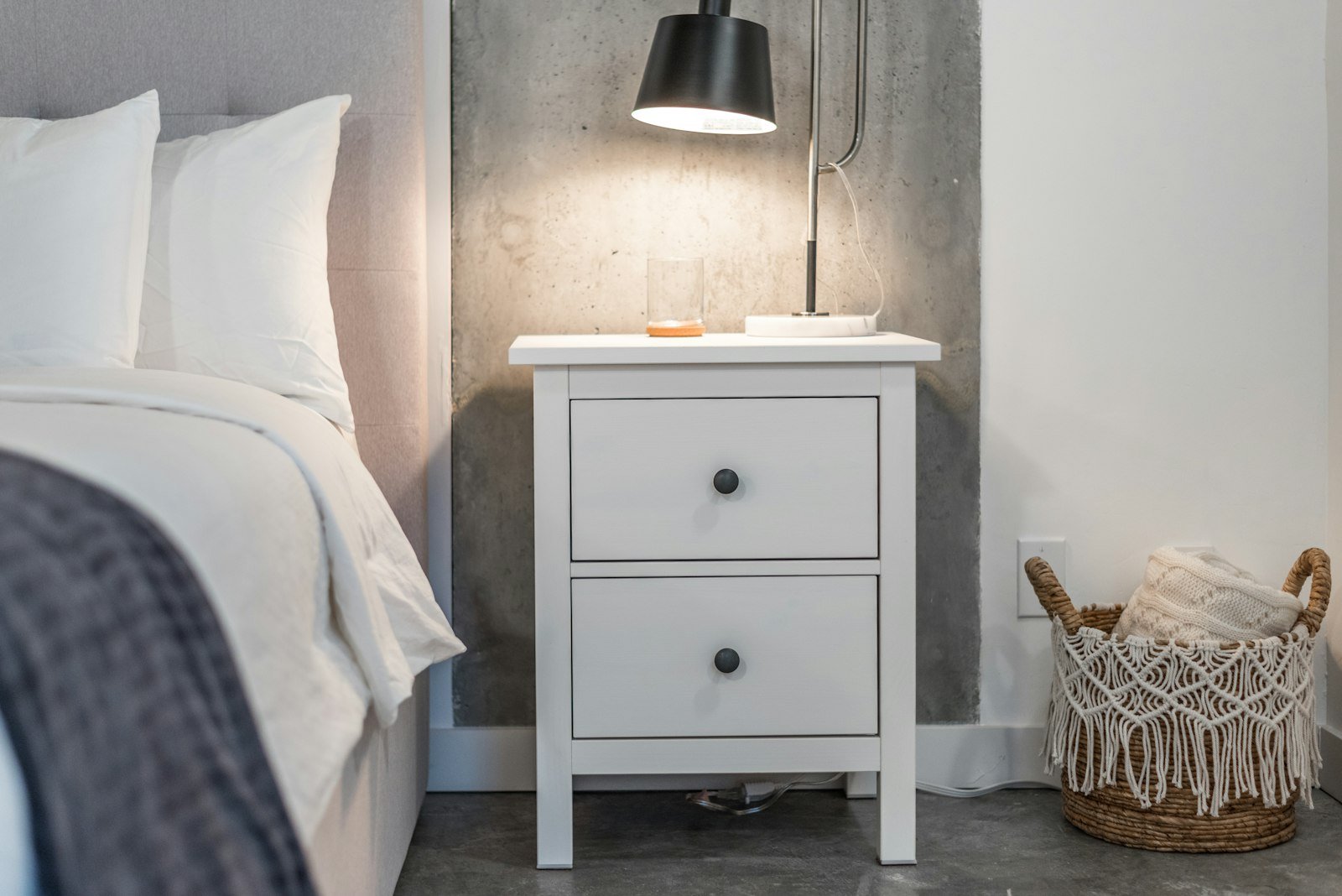 Neat bedroom with a low bed frame leaving room for under bed storage boxes
